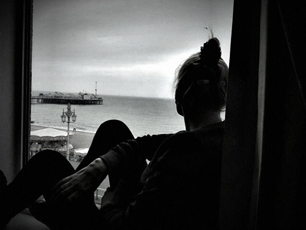 Sarah sat in the window relaxing with the view of the pier
