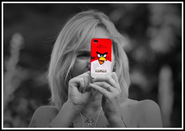 A photo of my lovely wife Sarah taking a photo of me with her iPhone that has a bright red Angry Birds cover