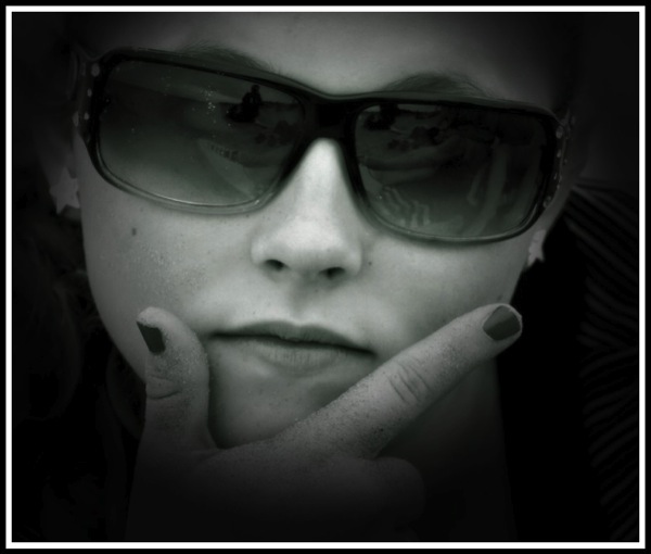 Really close up portrait of Maddie wearing sunglasses