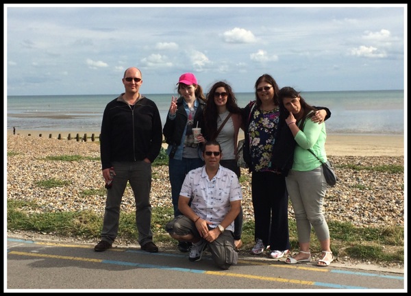 A group photo of us in front of the beach and sea