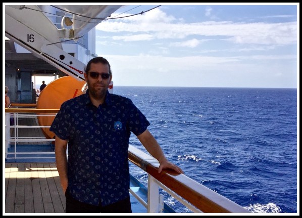 Me Birthday badge looking out over the sea, leaning on the teac bannister