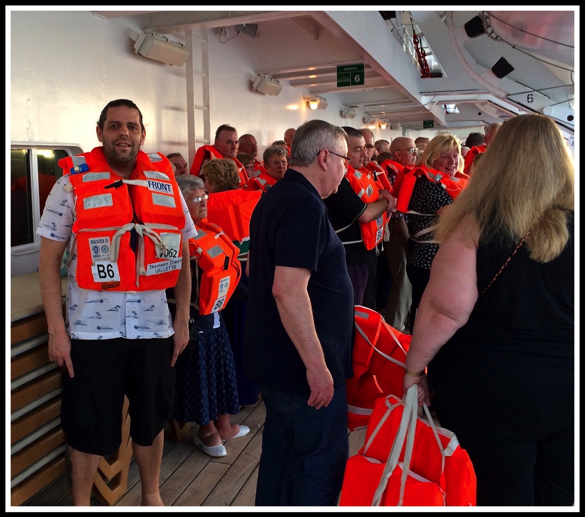 Me in life jacket on the left of the photo, with a lot of other people on deck 9 stood around with life jackets