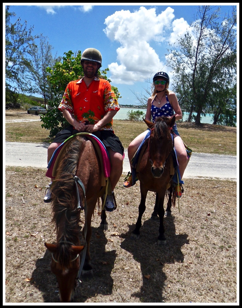 Photo of me9left and Sarah(right) sat on top of our horses. My horse is eating grass