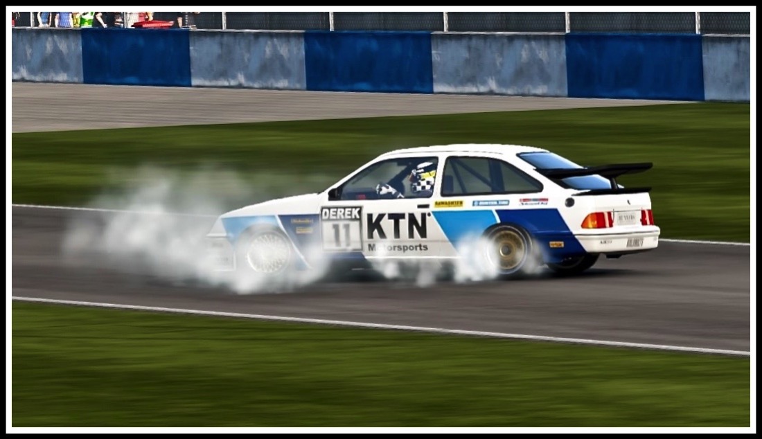 photo of a racing sierra cosworth with smoking tyres doing doughnuts at Donington race track