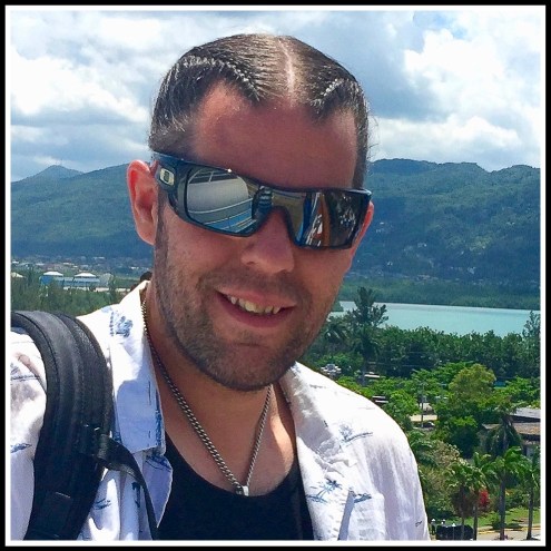 A portrait photo of me wearing Oakley Bat Wolf sunglasses and my hair braided