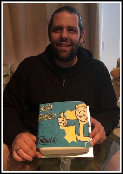 Me  holding my Fallout 4 Birthday Cake