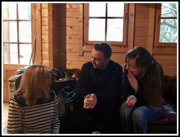 Sarah sitting on the floor on the left with Marshall(centre) on a leather sofa and Hope leaning in from the right