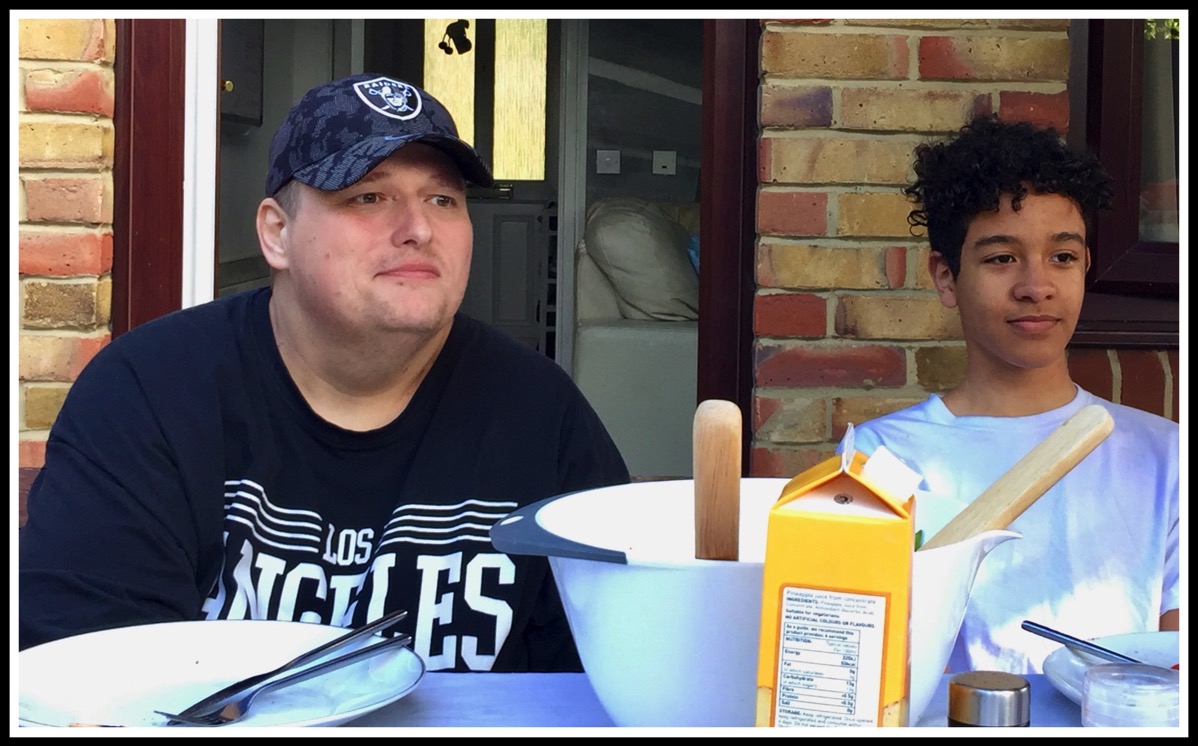 Paul  Vini sat at the table waiting for the BBQ