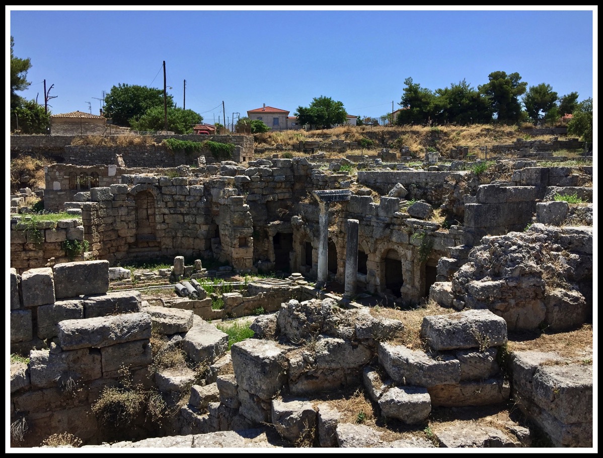 lots of stones which are the ruins of the Agora in Corinth