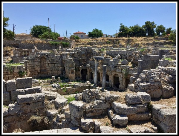 lots of stones which are the ruins of the Agora in Corinth