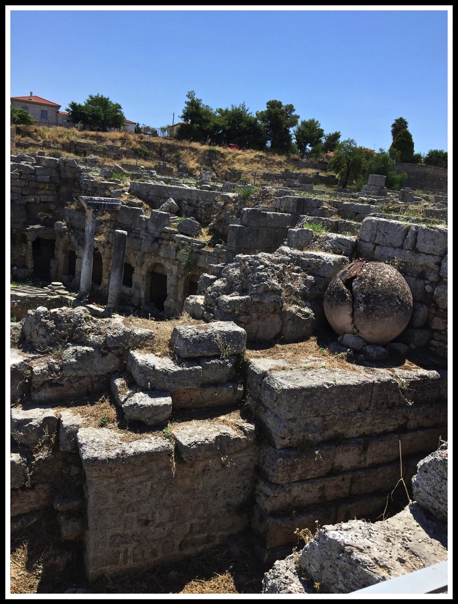 A portrait view of the the ruins of the Agora and Bema at ancient Corinth