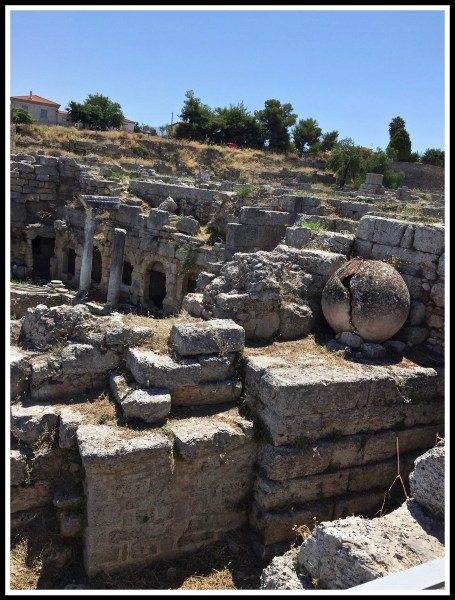 A portrait view of the the ruins of the Agora and Bema at ancient Corinth