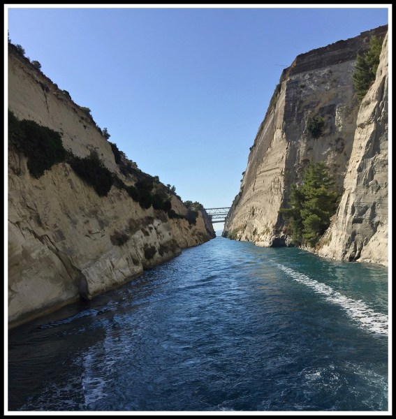 photo taken from the rear of the boat with the beautiful blue water with hight walls either side