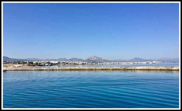 Another Sarah panorama with the sea and land stretching from end to end with rolling hills and mountains in the background