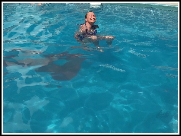 Sarah laughing and really enjoying swimming in the pool on the ship
