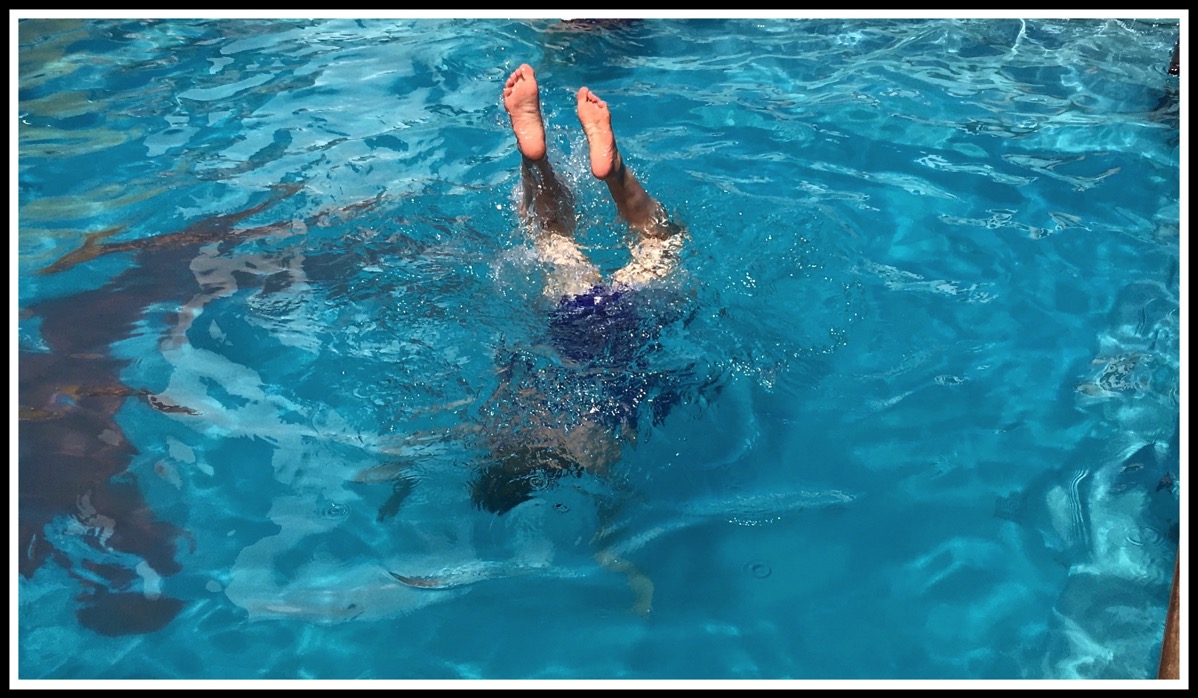 Sarah doing handstands in the swimming pool on the ship....Herr feet and legs are outside the water sticking up and her body is underwater!