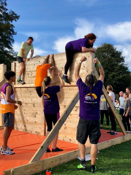Josie on the top of the wall with all of us cheering at the bottom