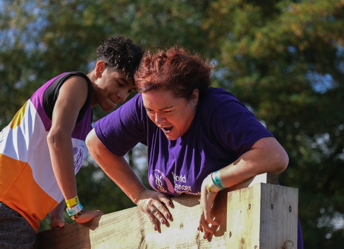Vini helping Josie at the top of the wall