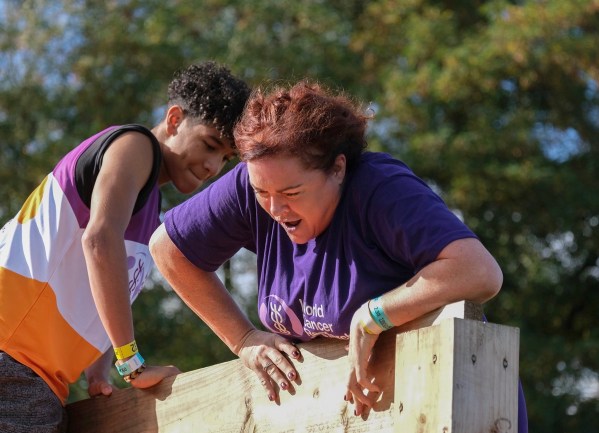 Vini helping Josie at the top of the wall