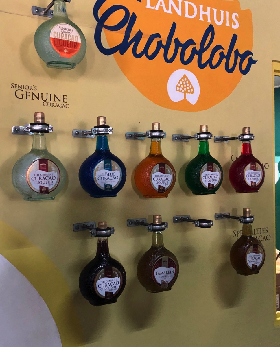 bottles of Curacao hanging on a display wall