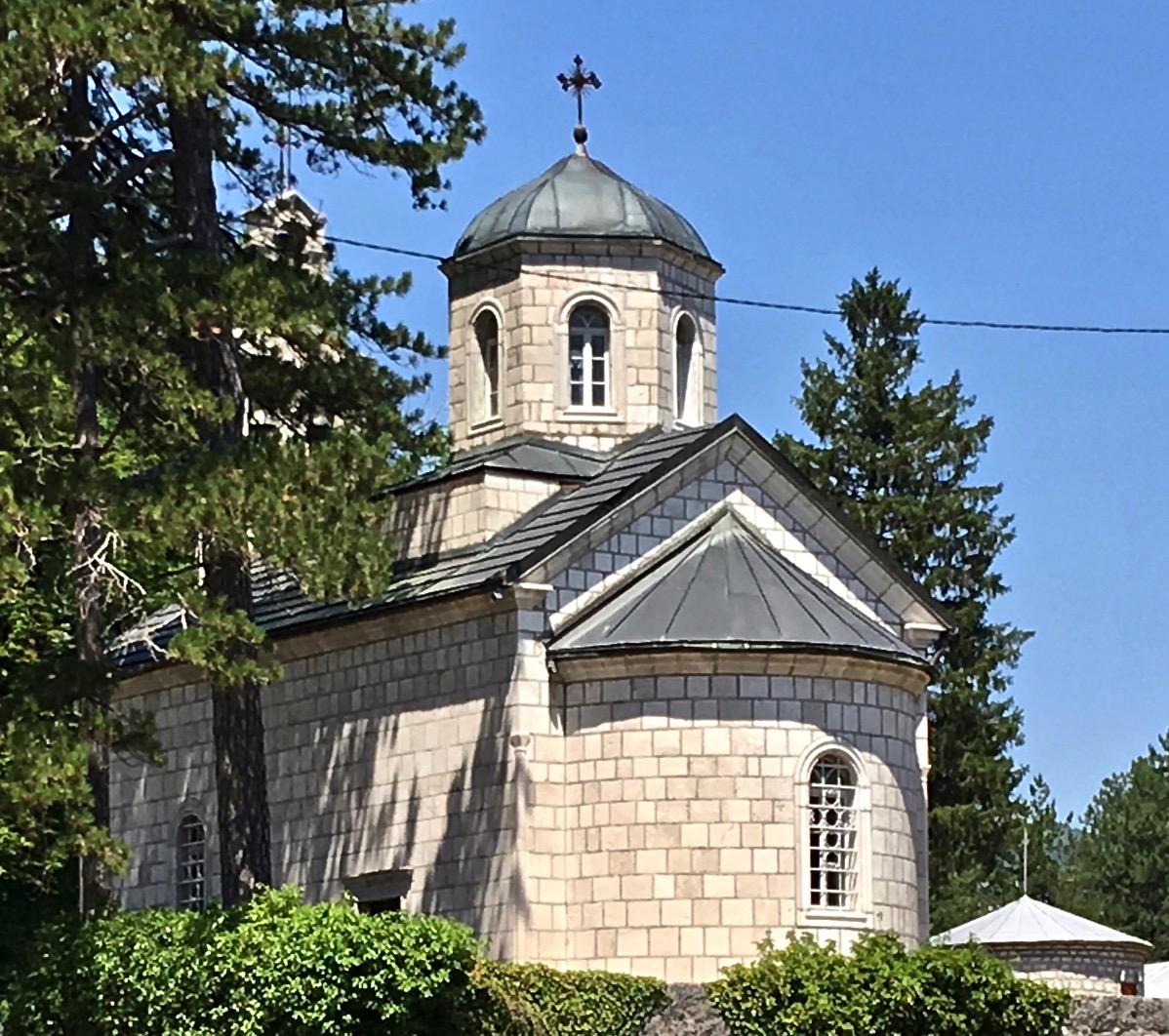 a closer shot of Old churh building amongost some trees