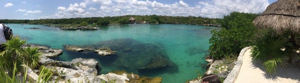 a panorama taken on one side of the river and looking over to the other side. The river running left to right