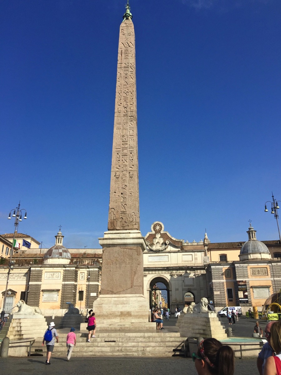 A really tall ponty tower with a large building at the bottom