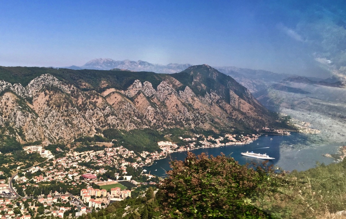 Beautiful landscape of the hills, mountains and down to the ship in the sea at the bottom of the valley