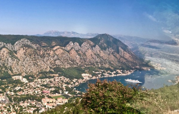 Beautiful landscape of the hills, mountains and down to the ship in the sea at the bottom of the valley