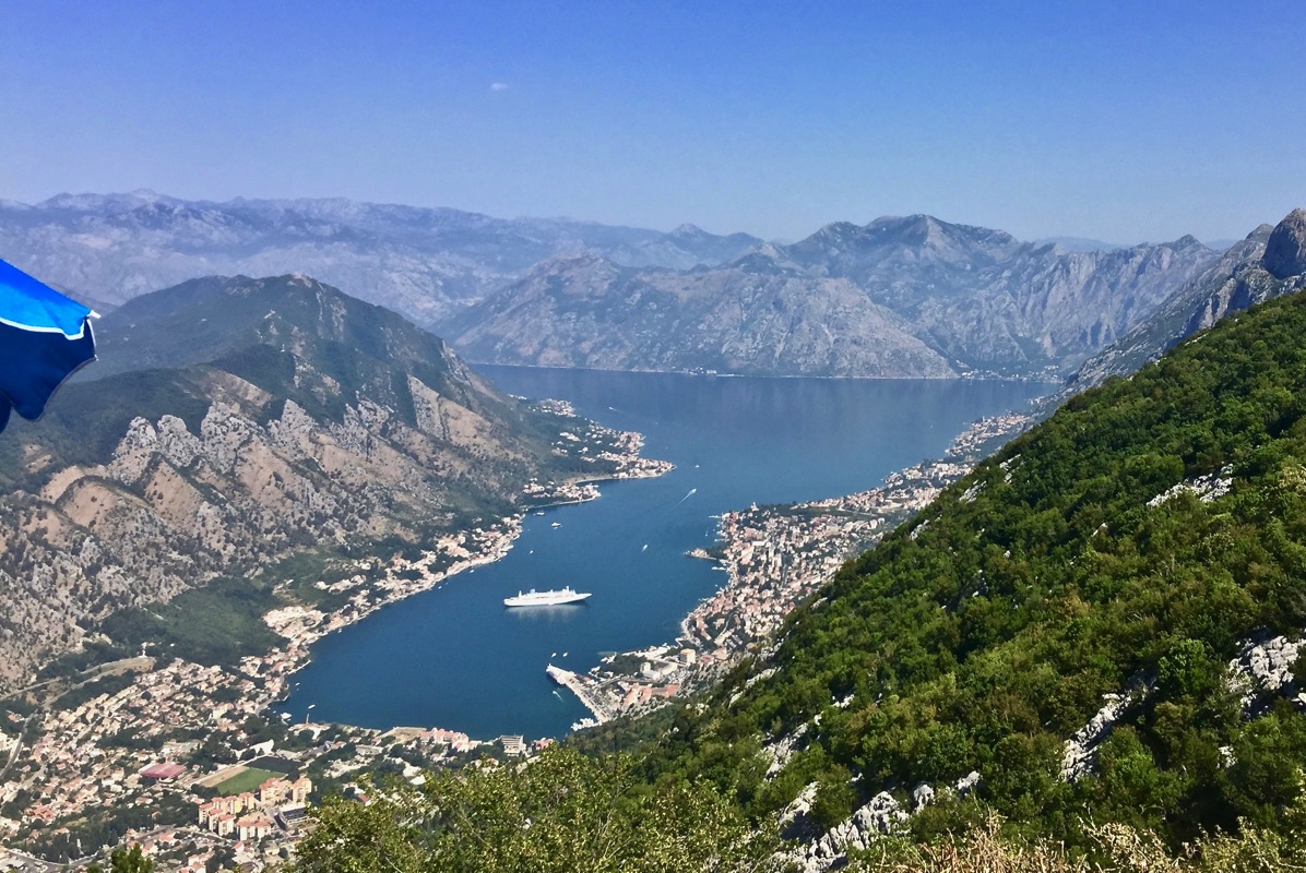 incredible shot of the surrounding mountains and then looking down to the ship at the bottom of the valley
