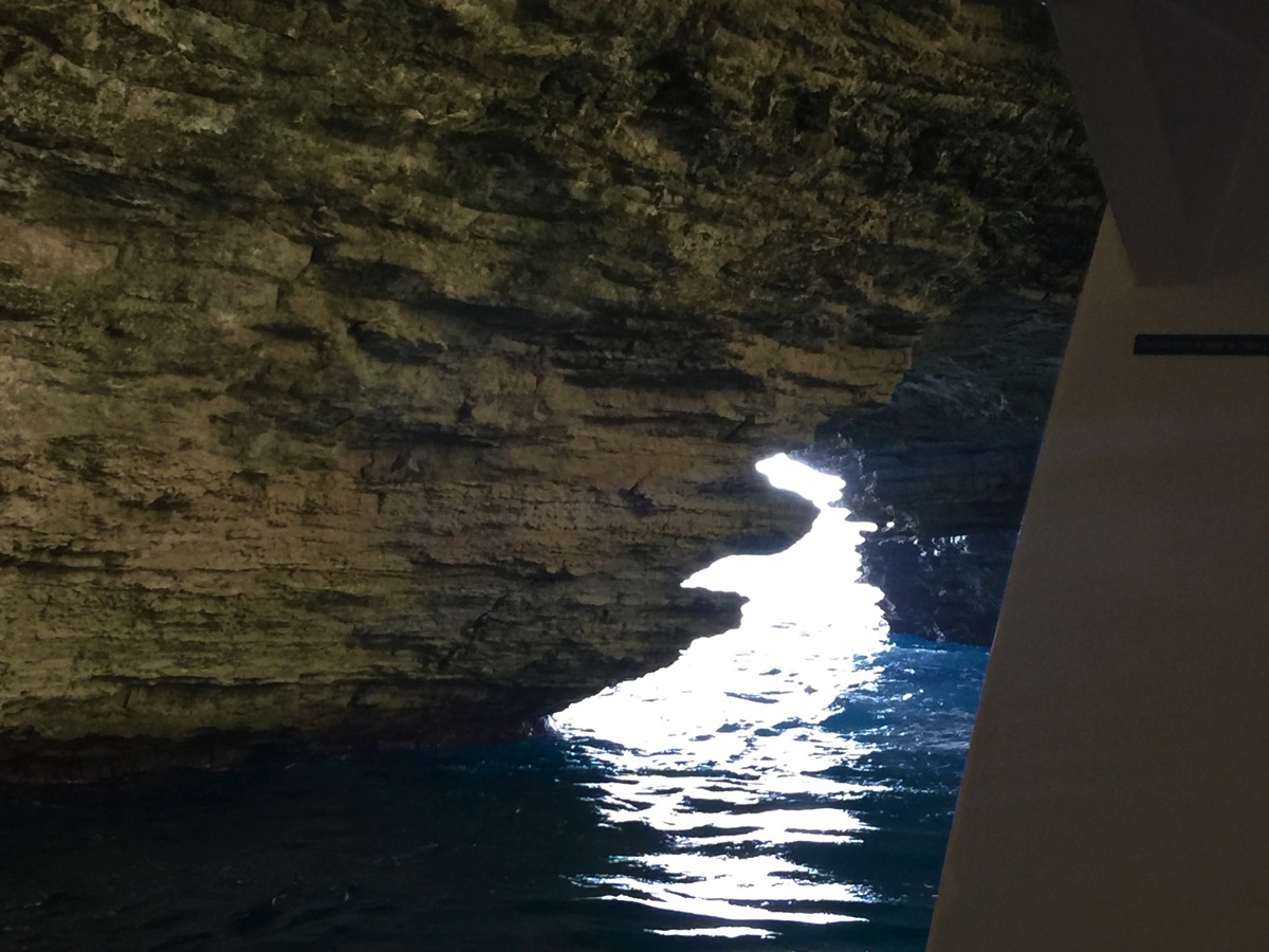 Inside the caves in Corsica with darkness all around and the light in the centre
