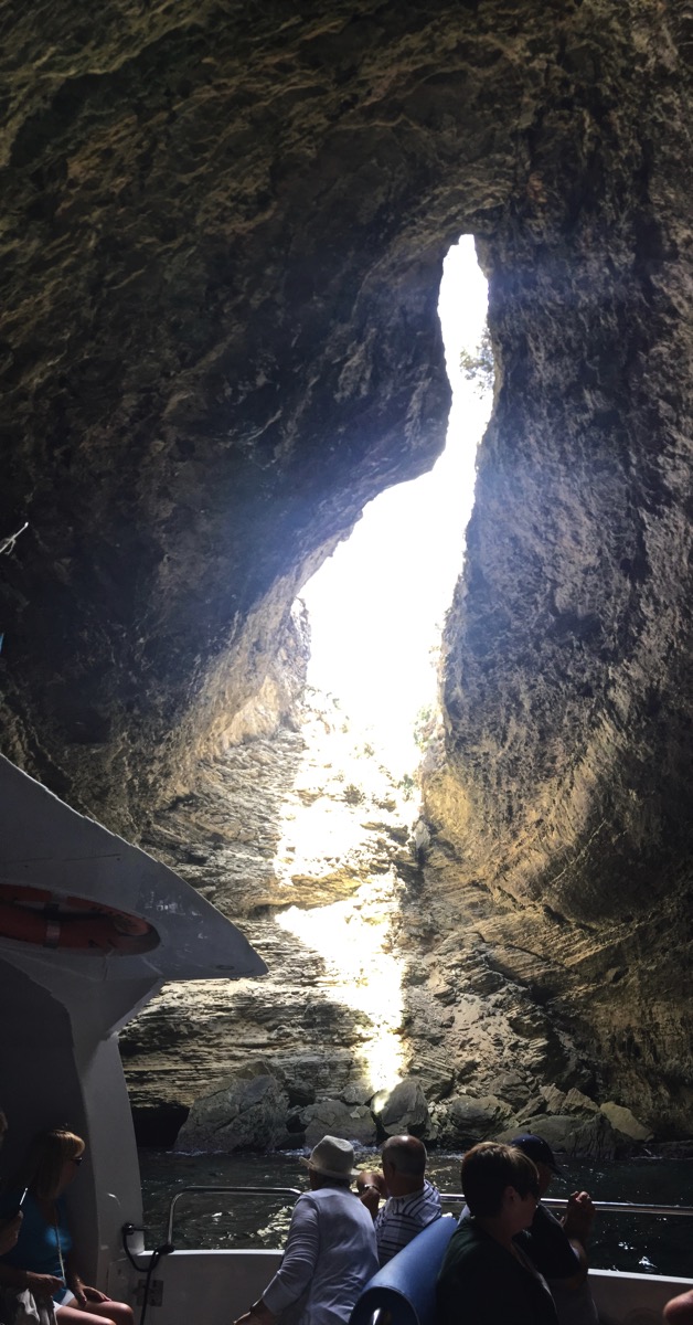 Inside the caves in Corsica with darkness all around and the light in the centre