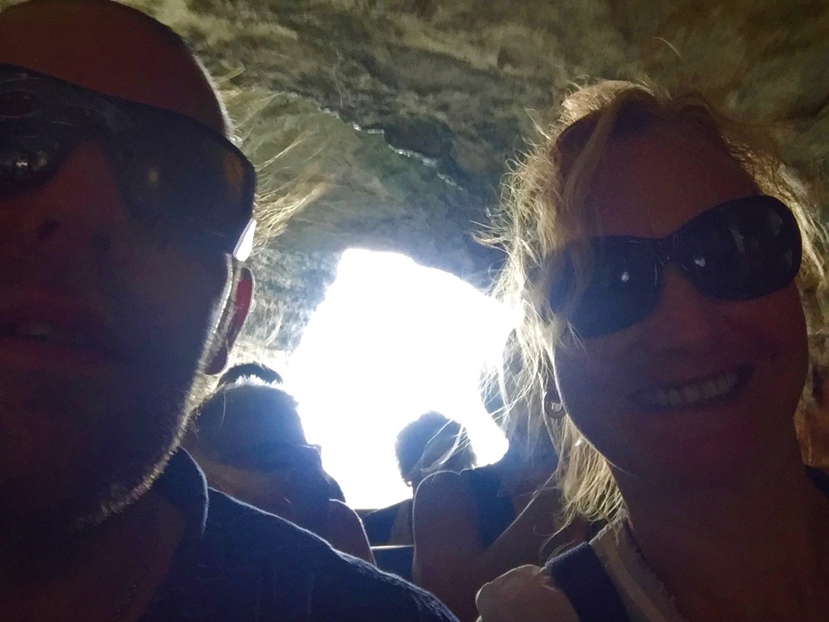 Inside the caves in Corsica with darkness all around and the light in the centre