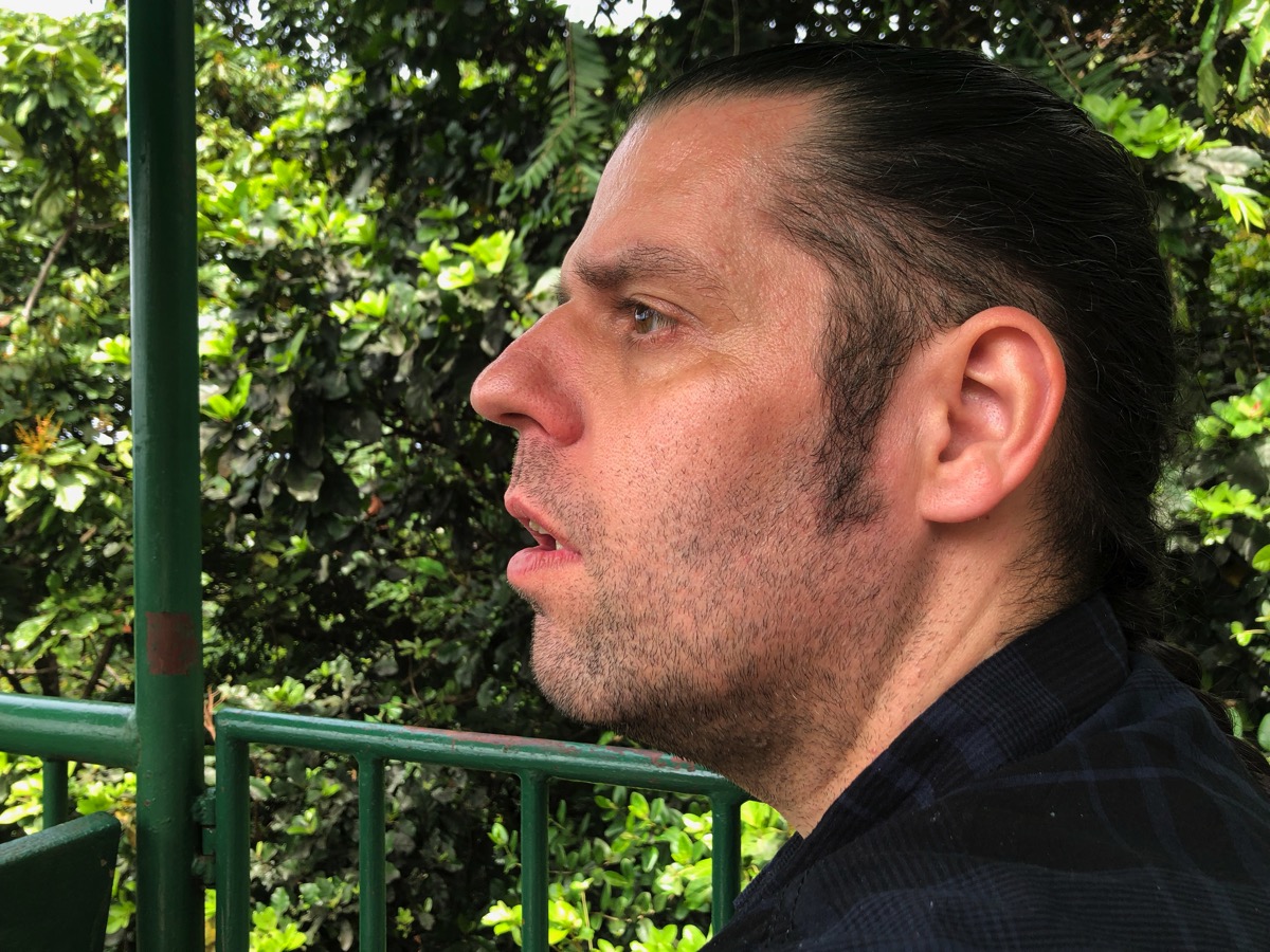 close side profile of my face as Sarah is sat right next to me and the rain forest behind me