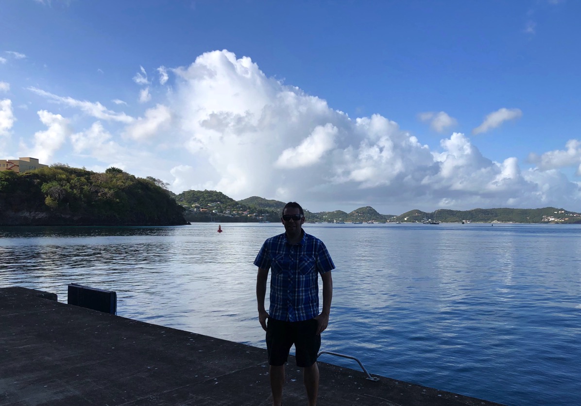 Me on the dock with the sea behind me and the cliffs slowly drifting into the sea behind me
