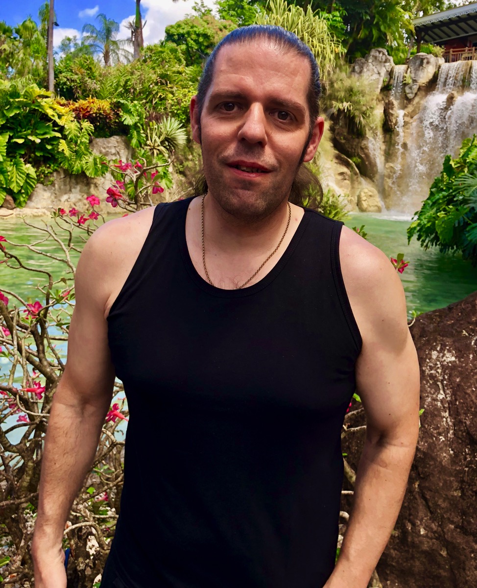 Me wearing a vest in the garden