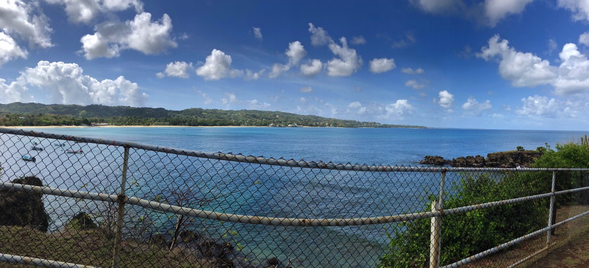 Panorama of the coast line through the fence
