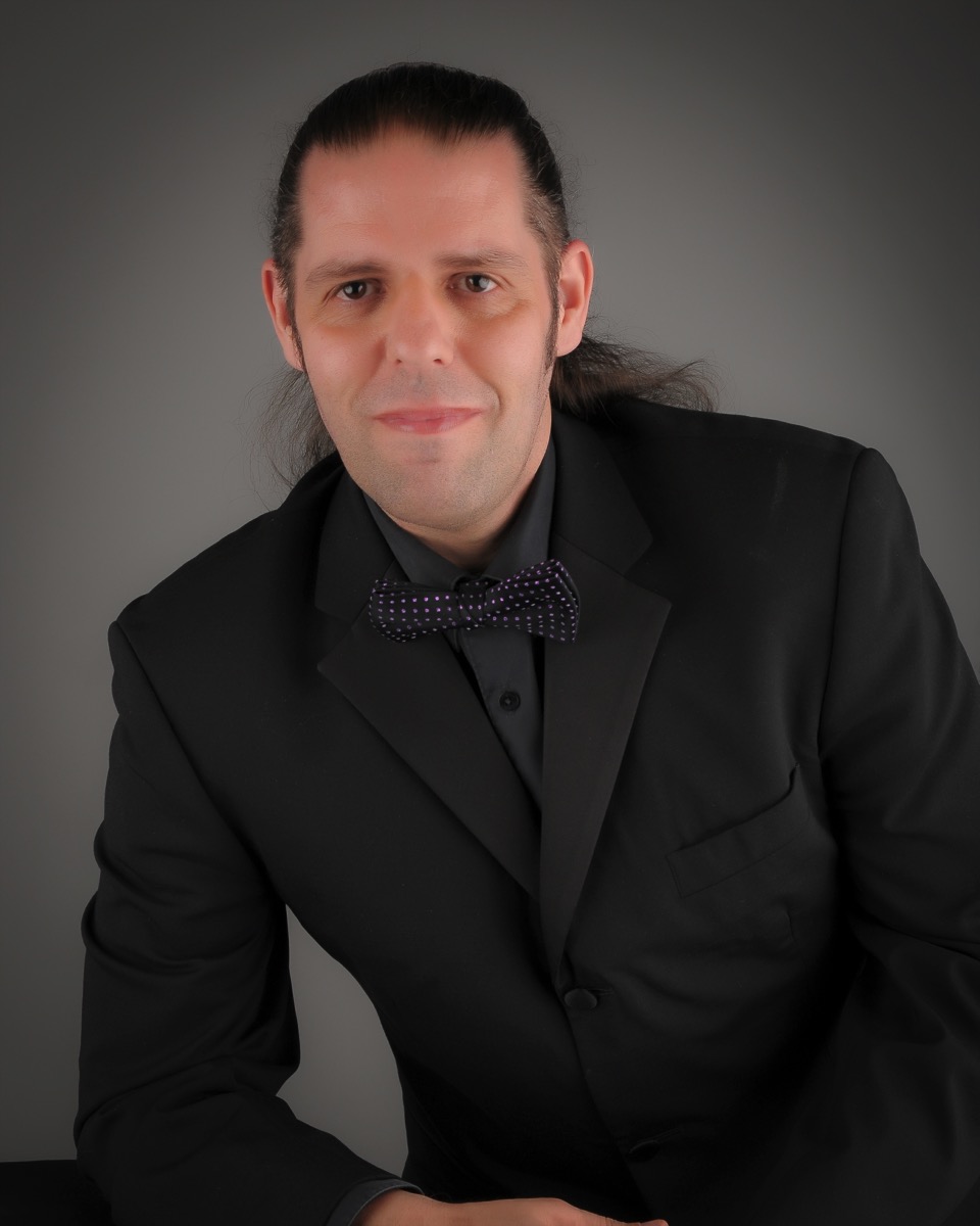 Photo of me in a suit and a purple spooty bow tie