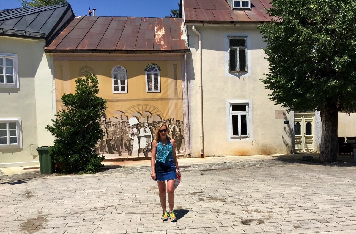 Lovely Sarah walking towards us inf front of a lovely old building 