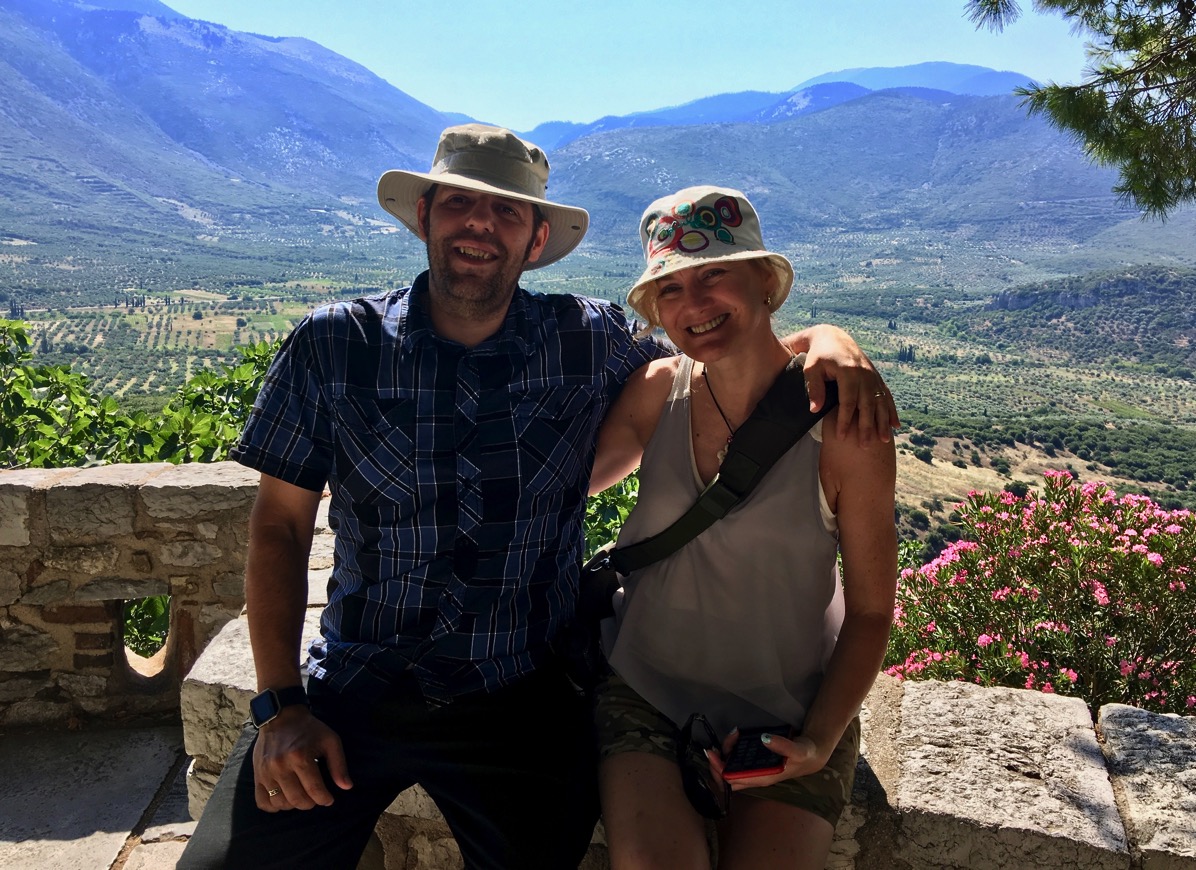 Me and Sarah with arms around each other and the rolling hills of olive trees etc behind us