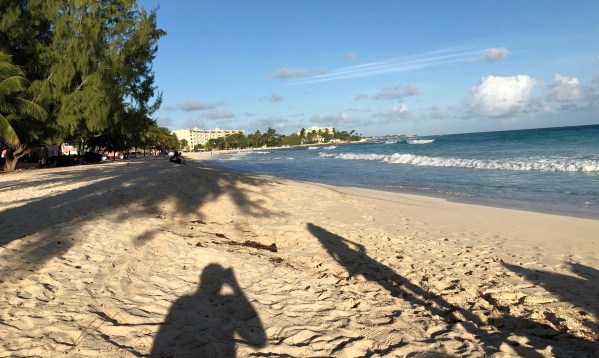 Sarah shadow across the beach looking over the whole bay of Barbados