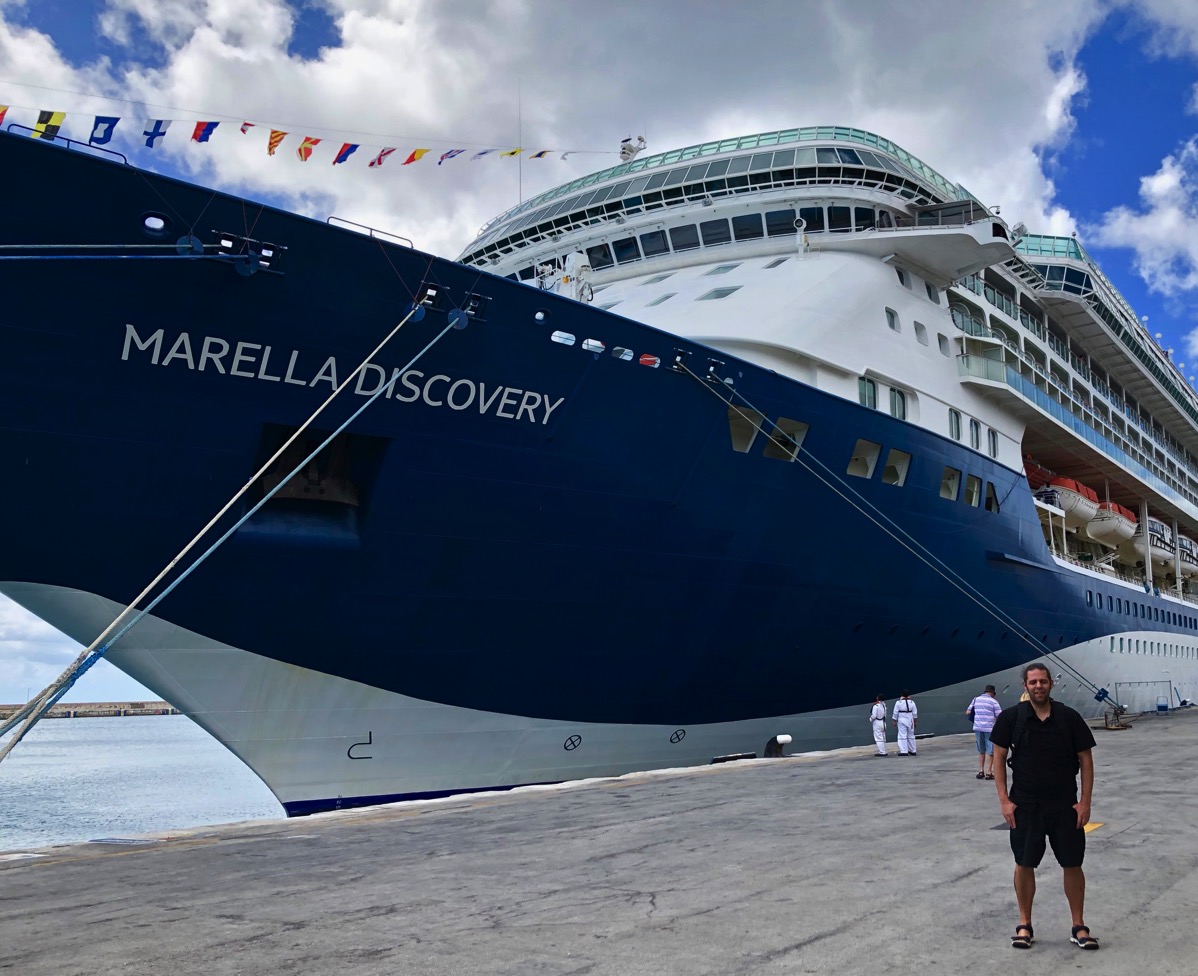 me stood on the dock next to the massive marella dicovery