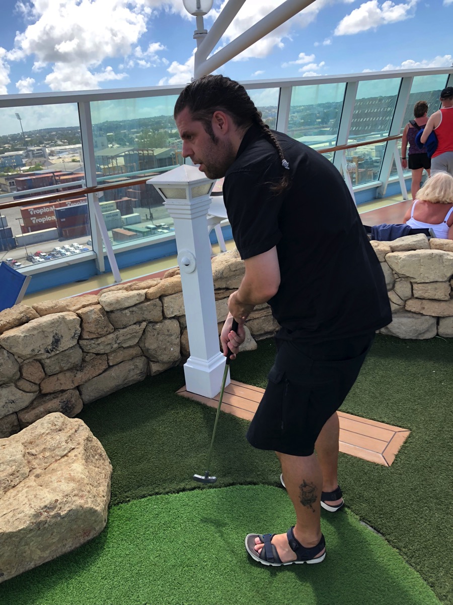 Me playing crazy golf on the top deck of the ship