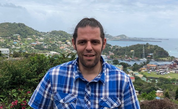 me in my blue chequed shirt in front of the green landscape and rolling hills