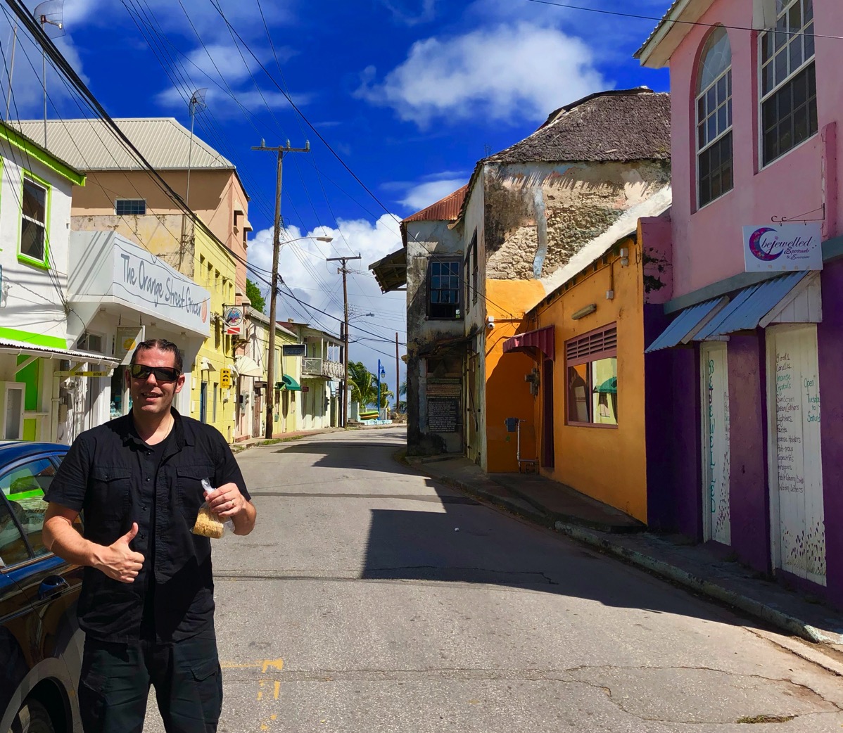 Me stood outsede the shop holding the coconut slice with my thumb sticking up and a big grin on my face!