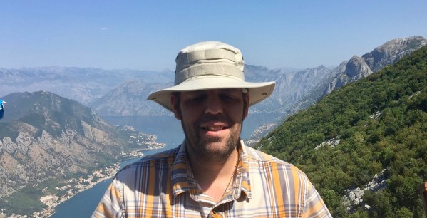 Me in my tactical sun hat stood in front of the mountains and valley