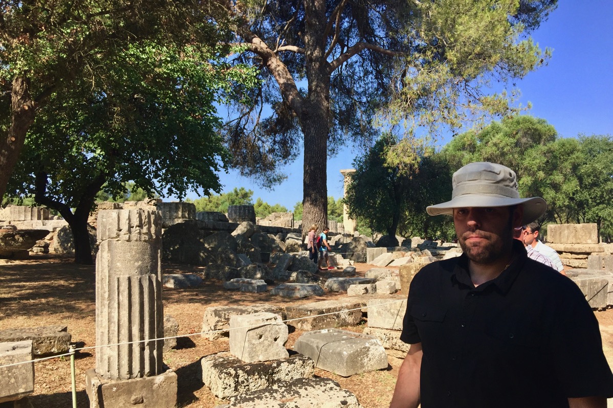 Me stood on the right hand side with my tactical sun hat and wearing a black shirt in front of the Olympic park
