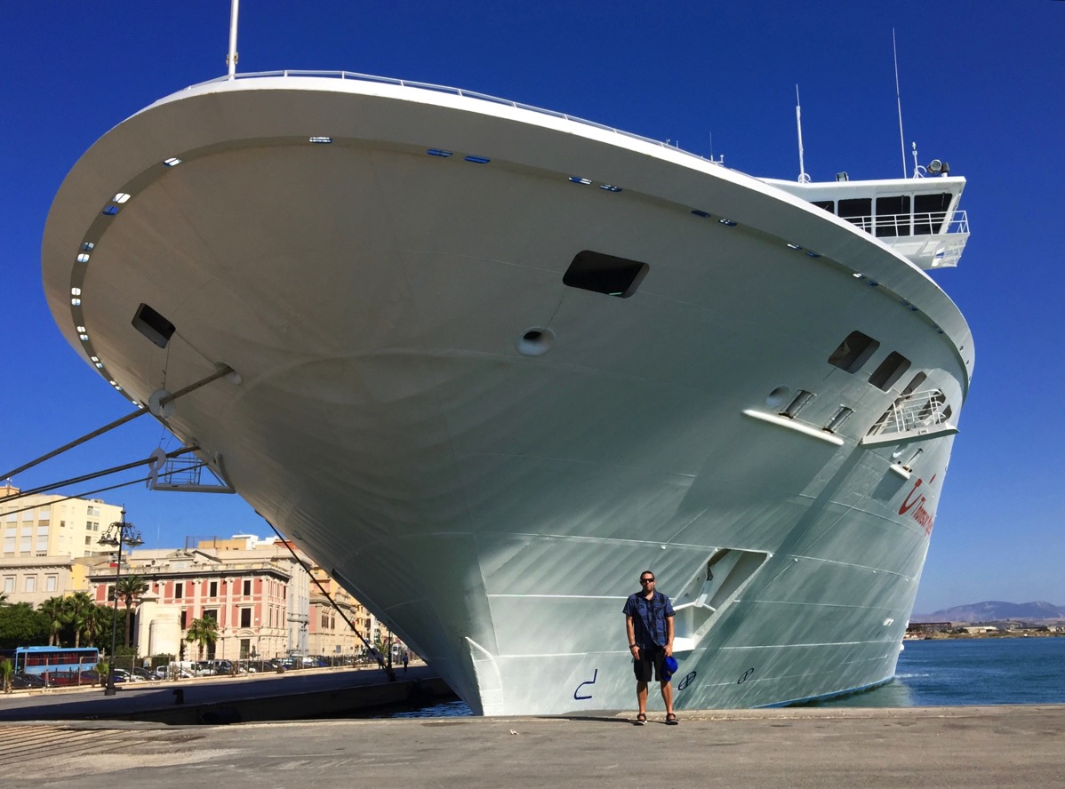 ME STOOD UNDERNEATH THE FRONT OF THE SHIP THAT LOOKS HUGE AND IS TOWERING OVER ME