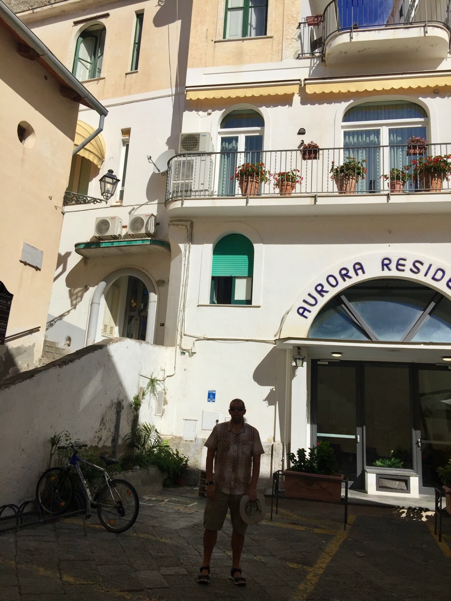 Me walking down some stairs in a built up town 