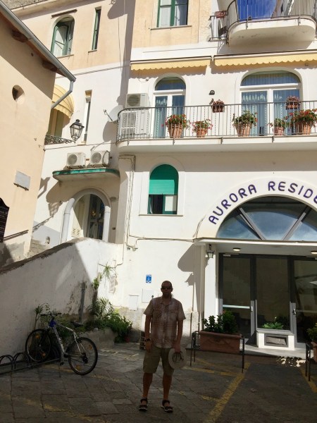 Me walking down some stairs in a built up town 